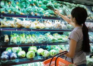 Woman are choosing vegetable in supermarket